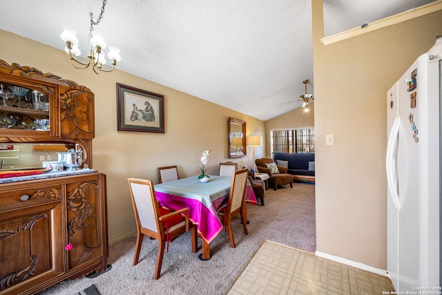 dining space featuring a textured ceiling, light carpet, ceiling fan with notable chandelier, and lofted ceiling