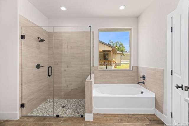 bathroom featuring independent shower and bath