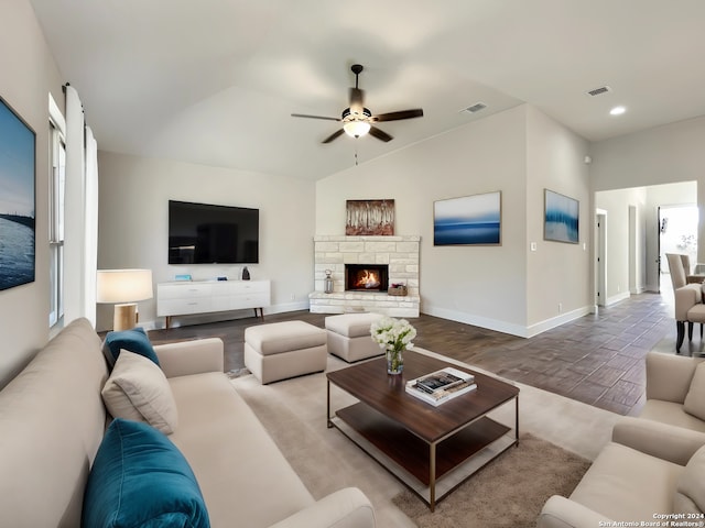 living room with ceiling fan, hardwood / wood-style floors, a fireplace, vaulted ceiling, and plenty of natural light