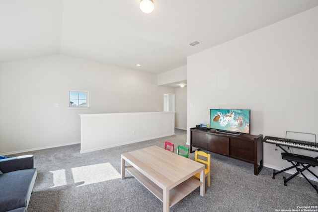 living room with vaulted ceiling and carpet