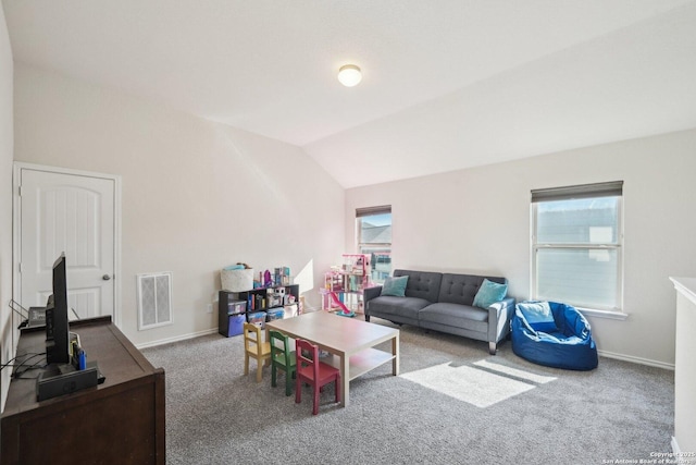 carpeted living room with vaulted ceiling