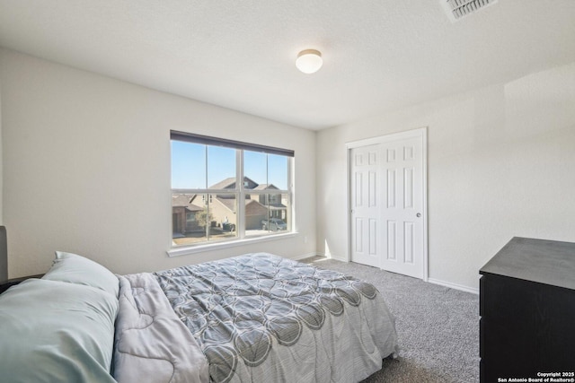 carpeted bedroom with a closet