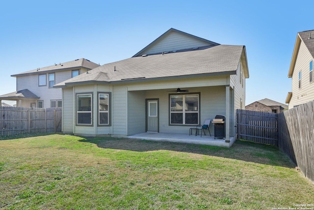 back of property featuring a patio area, a yard, and ceiling fan