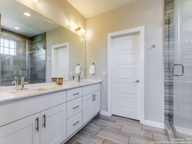 bathroom with vanity and an enclosed shower