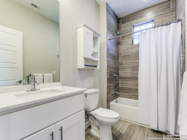 full bathroom with toilet, shower / bathtub combination with curtain, and vanity