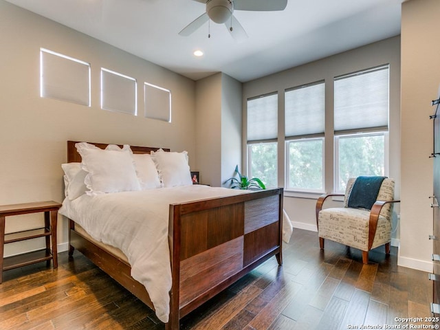 bedroom with ceiling fan and dark hardwood / wood-style floors