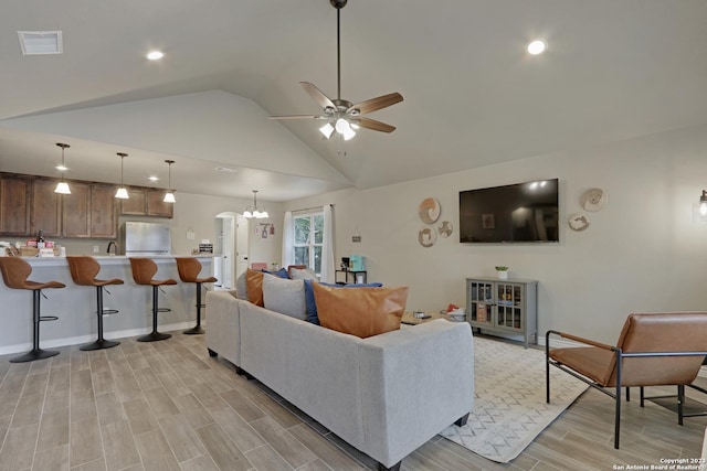 652 Canyon Bnd, Canyon Lake, TX 78133 - living room with light wood-type flooring, ceiling fan with notable chandelier, and lofted ceiling