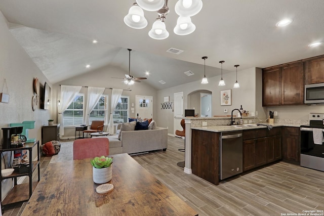 652 Canyon Bnd, Canyon Lake, TX 78133 - kitchen with kitchen peninsula, light hardwood / wood-style flooring, decorative light fixtures, sink, and stainless steel appliances
