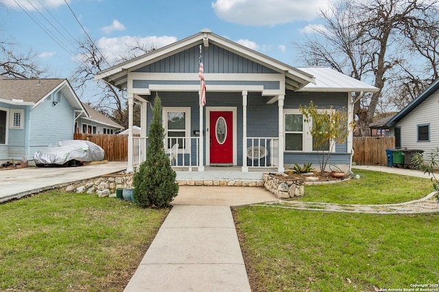 bungalow-style house with covered porch and a front lawn