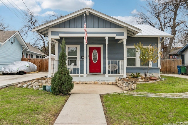 bungalow with a porch and a front yard