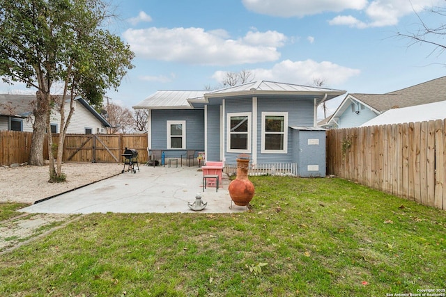 rear view of house with a yard and a patio