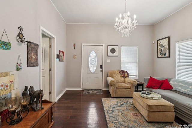 entryway featuring a healthy amount of sunlight, an inviting chandelier, and dark hardwood / wood-style flooring