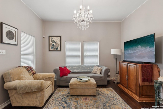 living room with a notable chandelier and dark hardwood / wood-style flooring