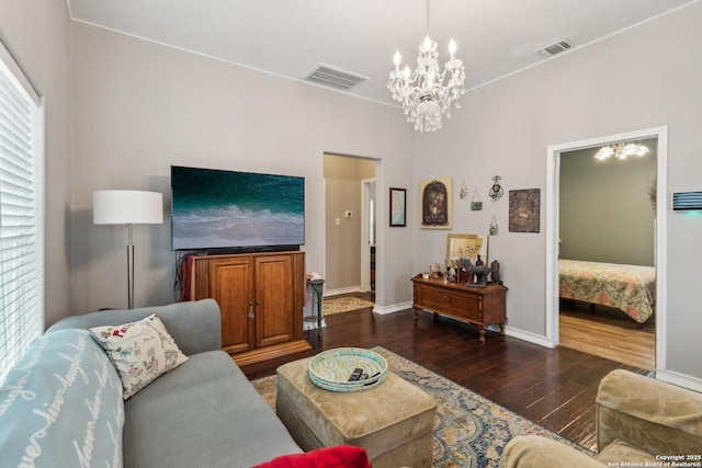 living room featuring a healthy amount of sunlight, a notable chandelier, and dark hardwood / wood-style flooring