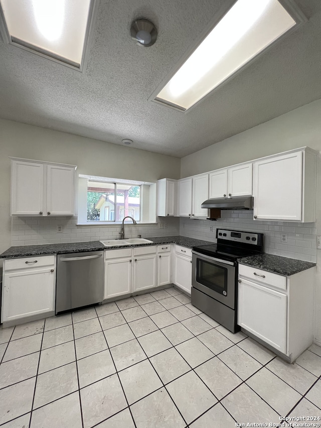 kitchen featuring sink, white cabinets, a textured ceiling, and appliances with stainless steel finishes