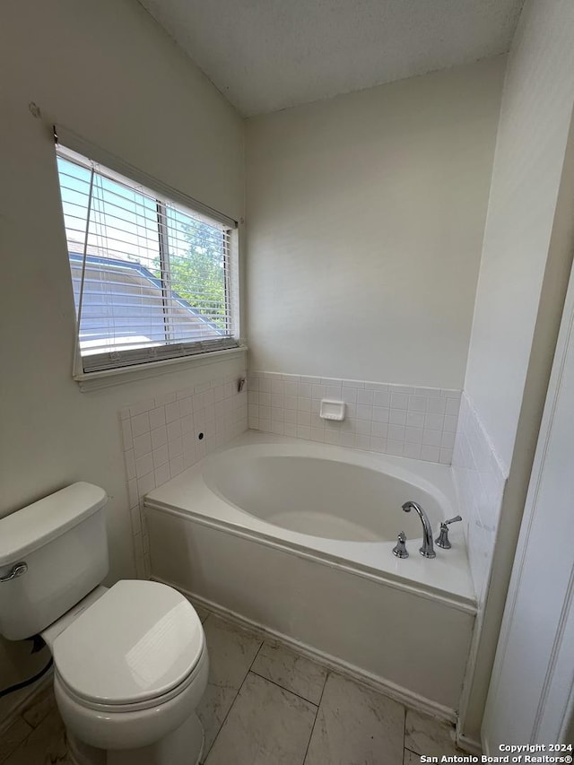 bathroom featuring toilet and a bath