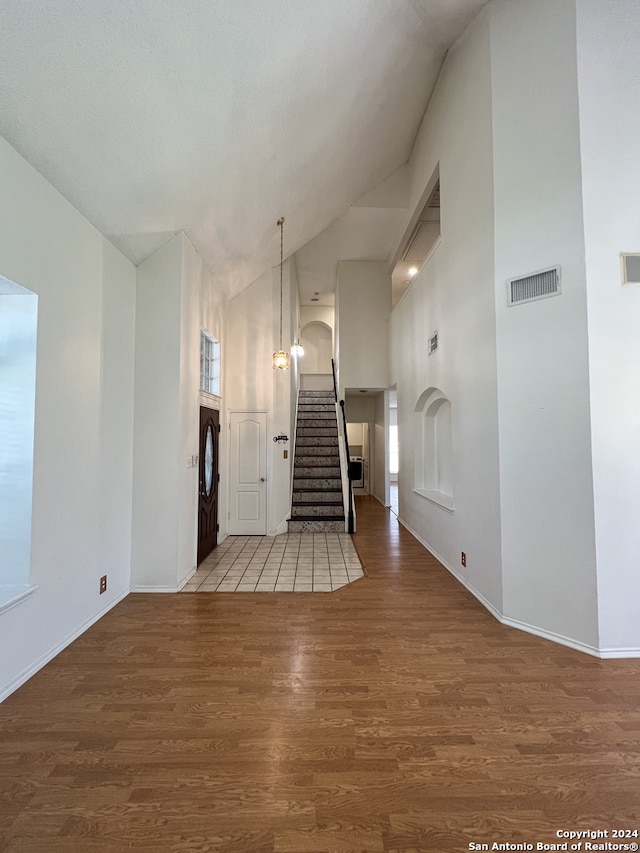 interior space featuring hardwood / wood-style floors and vaulted ceiling