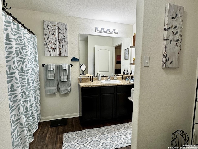 bathroom with vanity, hardwood / wood-style floors, and a textured ceiling