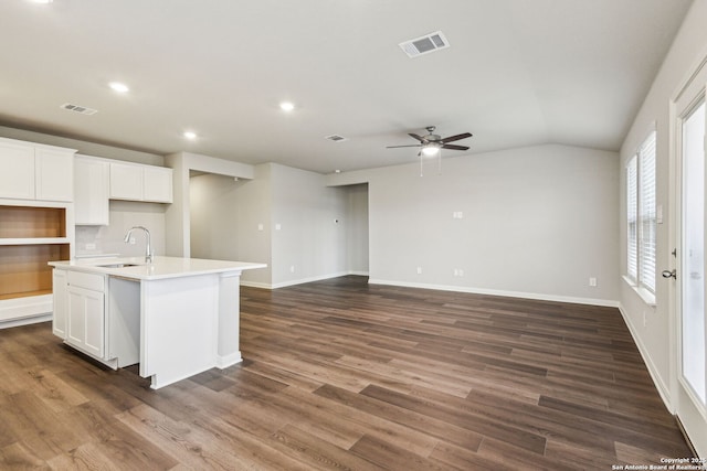 kitchen with a kitchen island with sink, sink, and white cabinetry