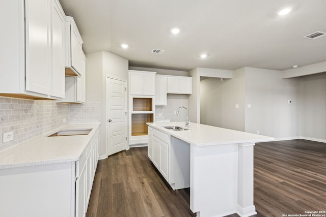 kitchen featuring white cabinetry, sink, dark hardwood / wood-style floors, and an island with sink