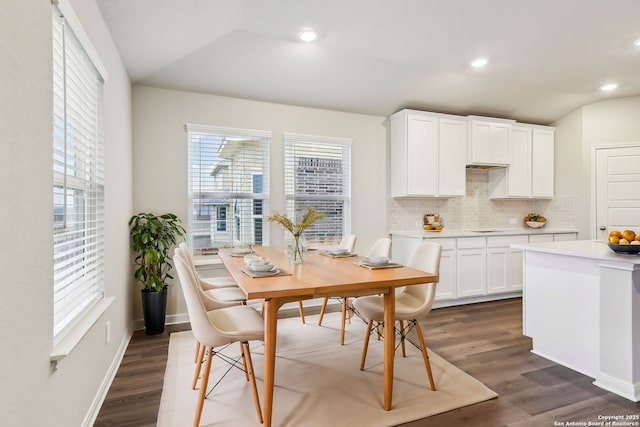 dining area with lofted ceiling and dark hardwood / wood-style flooring