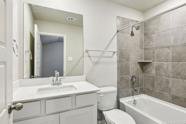 full bathroom with vanity, toilet, and tiled shower / bath combo