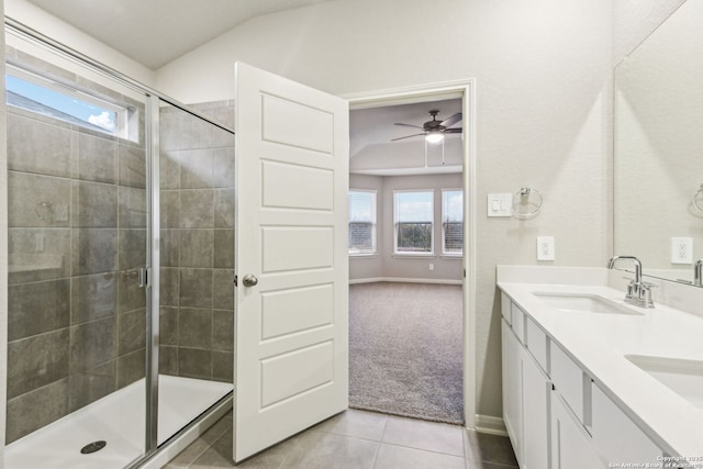 bathroom featuring tile patterned floors, a shower with shower door, vaulted ceiling, and vanity