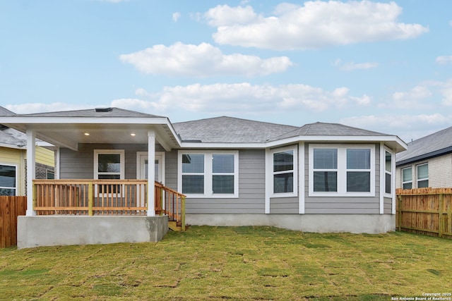 rear view of property featuring a yard