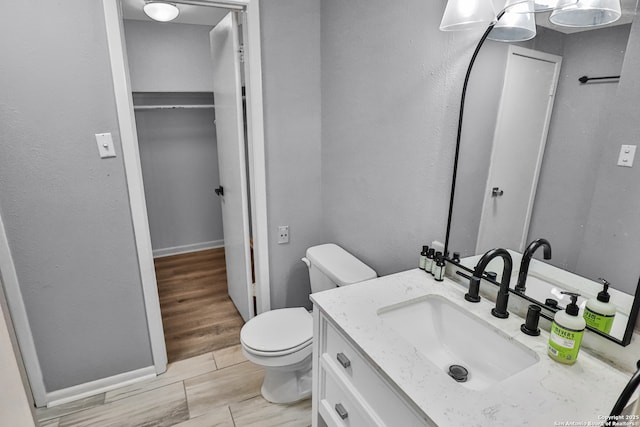 bathroom featuring toilet and vanity