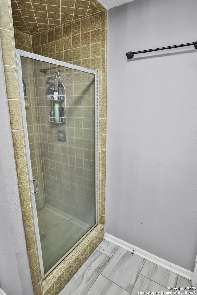 bathroom with a shower with door