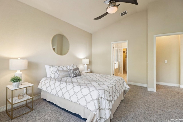 carpeted bedroom featuring ceiling fan, vaulted ceiling, and ensuite bath