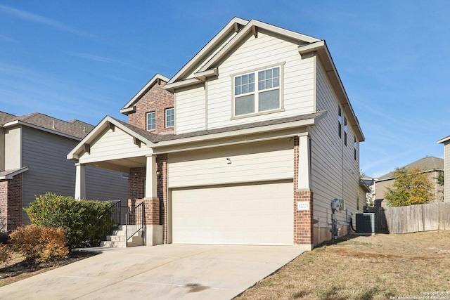 craftsman house with central AC and a garage