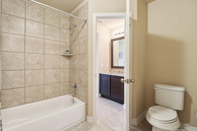 full bathroom with tiled shower / bath combo, toilet, tile patterned floors, and vanity