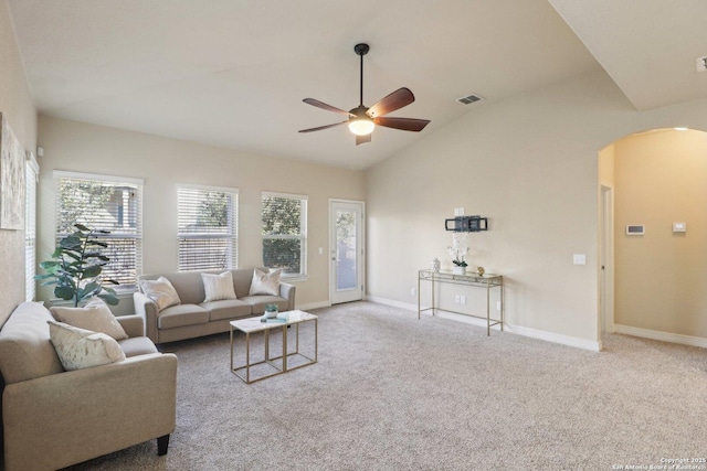 living room featuring ceiling fan, light colored carpet, a wealth of natural light, and lofted ceiling