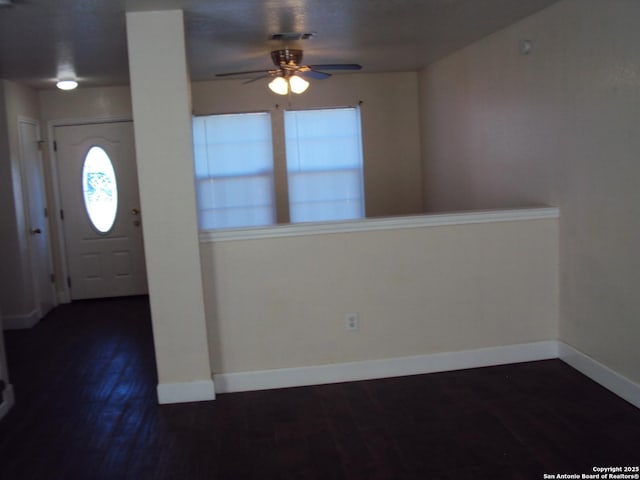 foyer with ceiling fan and dark hardwood / wood-style floors