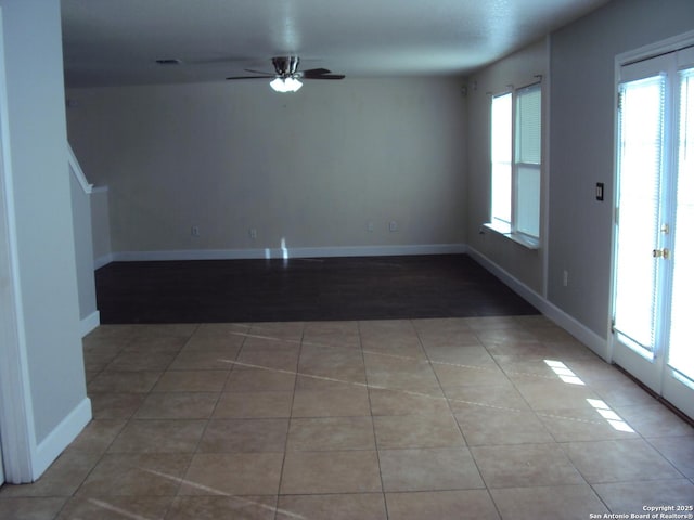 tiled empty room with ceiling fan