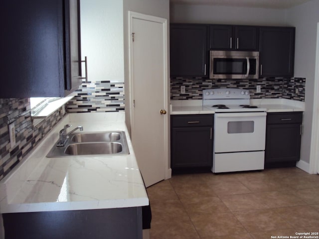 kitchen featuring white range with electric cooktop, backsplash, sink, and light tile patterned floors