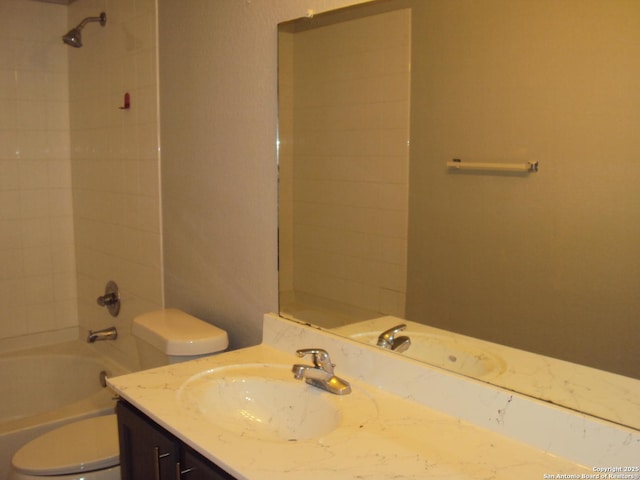 full bathroom featuring toilet, vanity, and tiled shower / bath combo