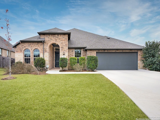 view of front of house featuring a garage and a front lawn