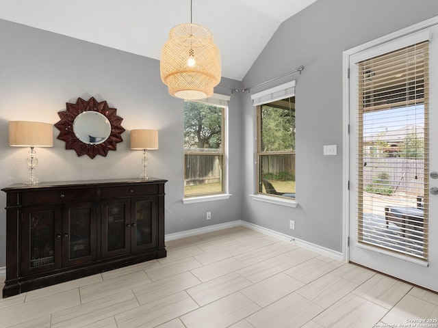 unfurnished dining area with vaulted ceiling