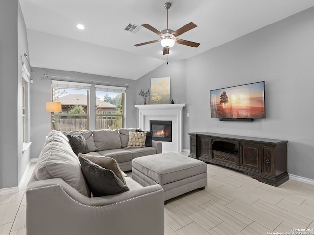 living room with ceiling fan and vaulted ceiling