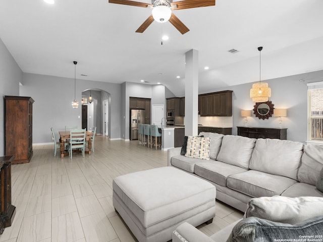 living room featuring sink and ceiling fan