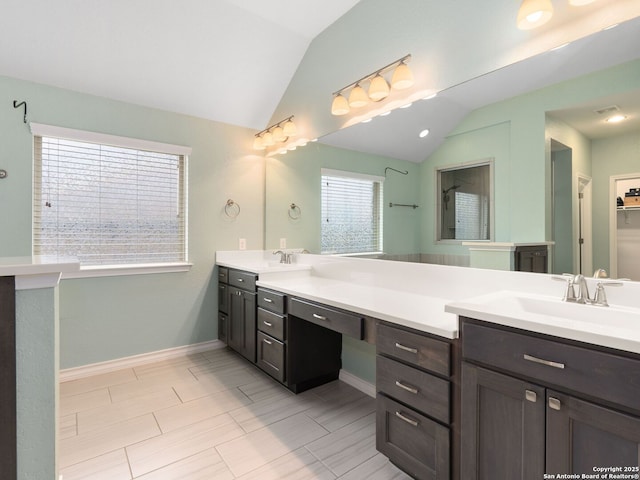 bathroom with vanity and vaulted ceiling