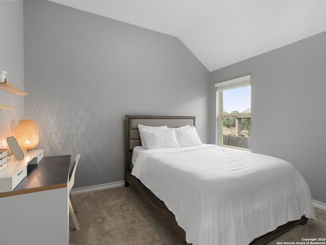 bedroom with dark carpet and lofted ceiling