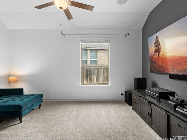 living area with ceiling fan, light carpet, and lofted ceiling