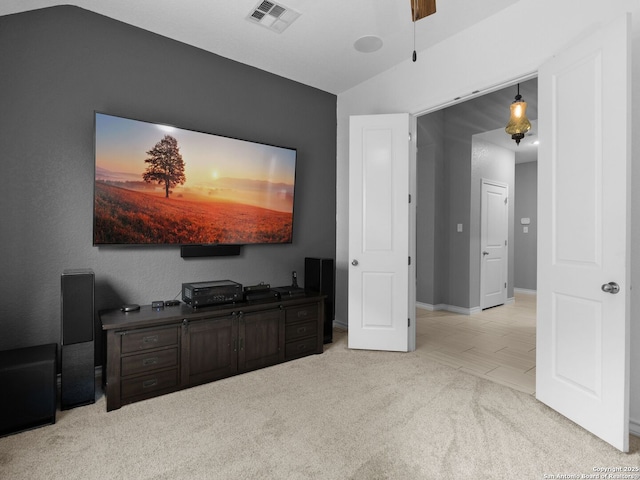 interior space with vaulted ceiling and light carpet