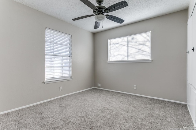 carpeted empty room featuring a textured ceiling and ceiling fan