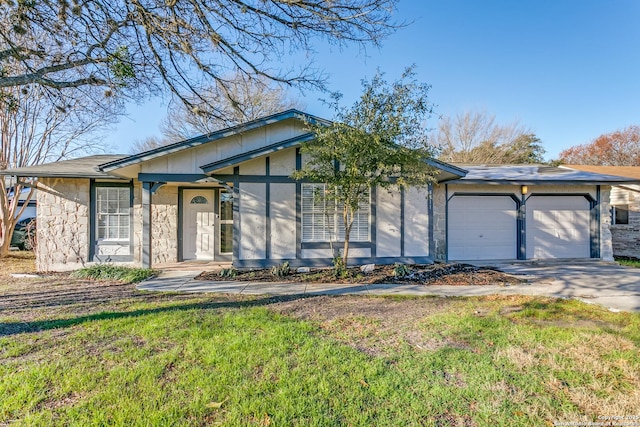 ranch-style home featuring a garage and a front lawn