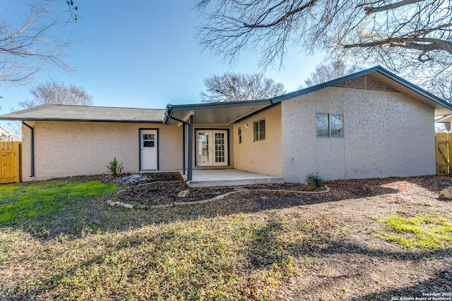 view of front of house featuring a front lawn and a patio