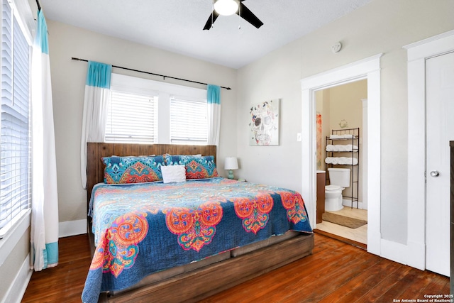 bedroom featuring dark hardwood / wood-style floors, connected bathroom, and ceiling fan